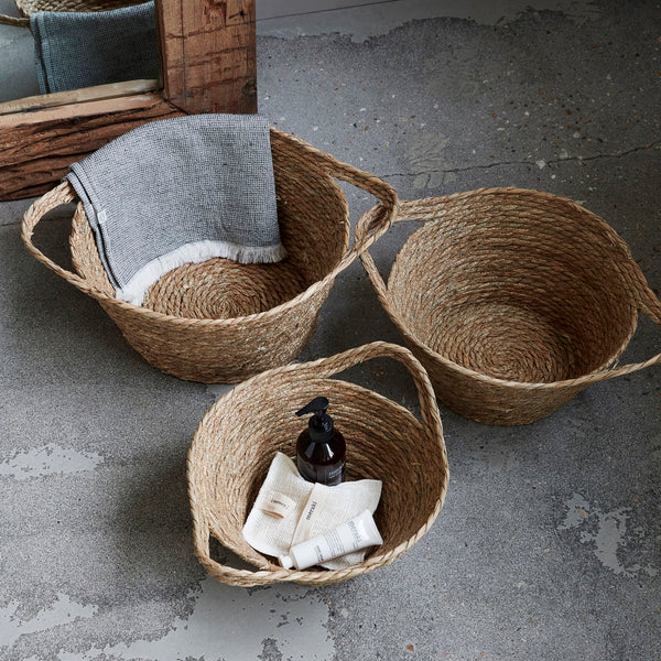 Set of three natural seagrass woven baskets with handles
