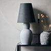 grey sculptural cement table lamp with linen shade