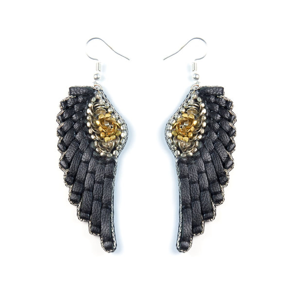 Handmade leather earrings, adorned with sequins and beads, in the shape of angel wings. 