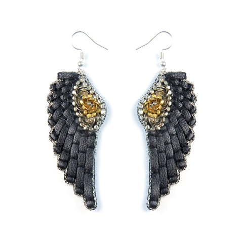 Handmade leather earrings, adorned with sequins and beads, in the shape of angel wings. 