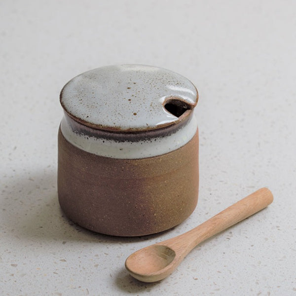 Stoneware sugar bowl with wooden spoon