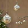 Round glass baubles with rustic gold finish