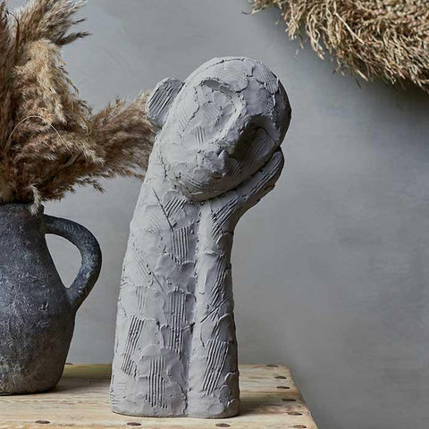 Abstract head in hand sculpture cement